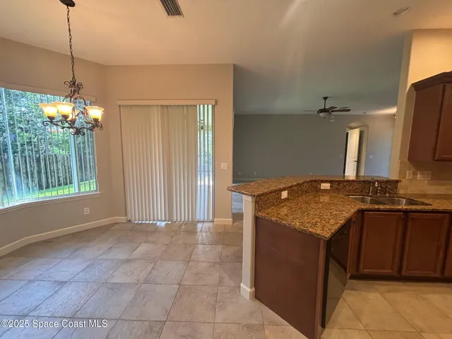 a kitchen with a stove and a wooden cabinets