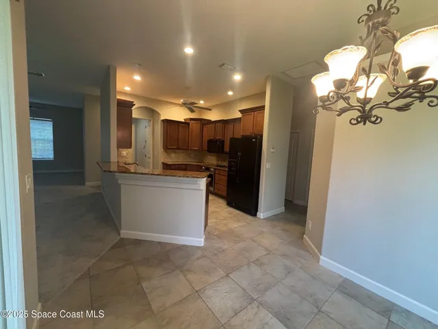 a view of a kitchen with a sink and cabinets