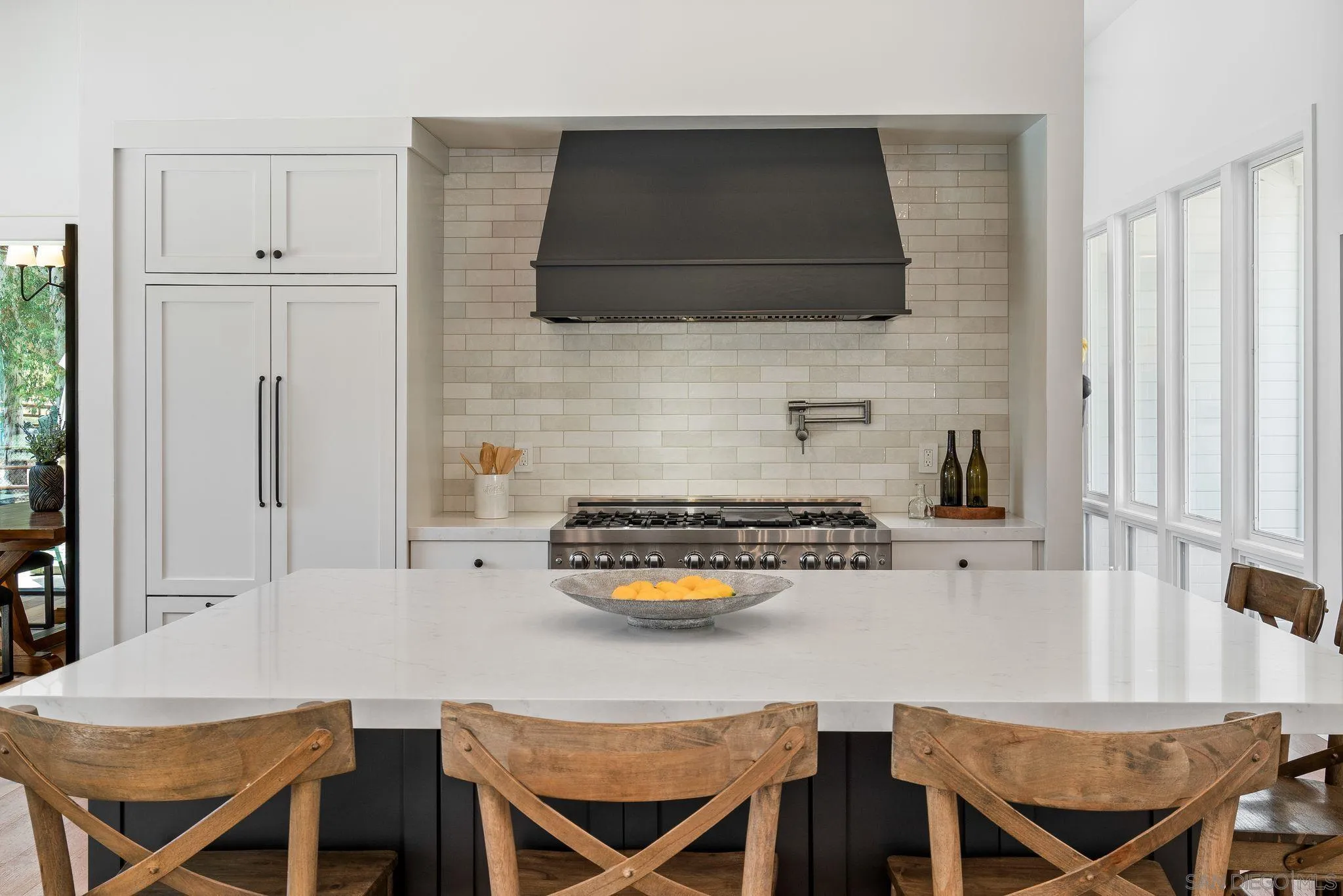 3355 Dove Hollow Road Encinitas, CA 92024 - Photo 11 of 37 a kitchen with stainless steel appliances a stove a table and chairs