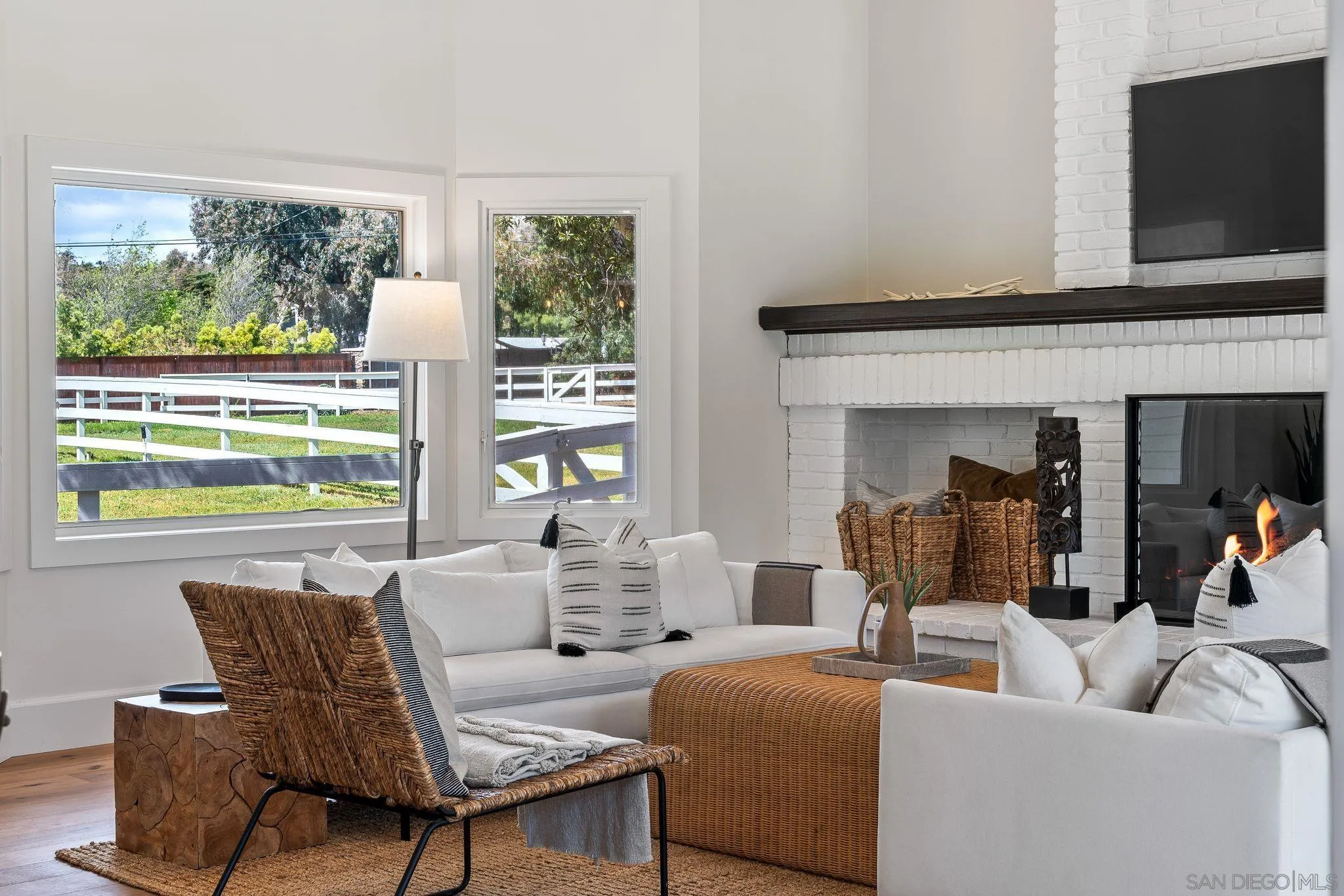 3355 Dove Hollow Road Encinitas, CA 92024 - Photo 13 of 37 a living room with furniture a flat screen tv and a floor to ceiling window
