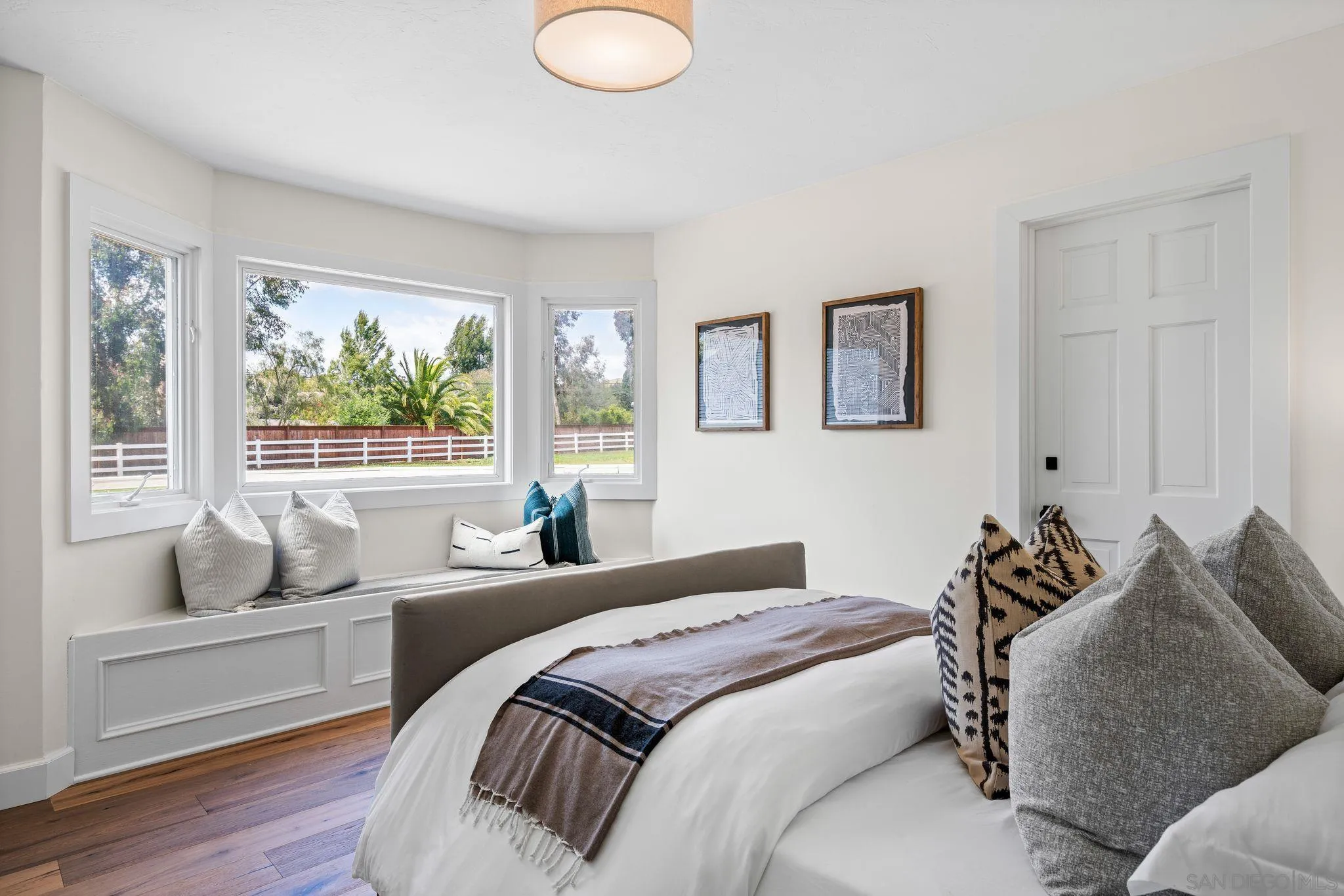 3355 Dove Hollow Road Encinitas, CA 92024 - Photo 20 of 37 a bedroom with a bed and wooden floor