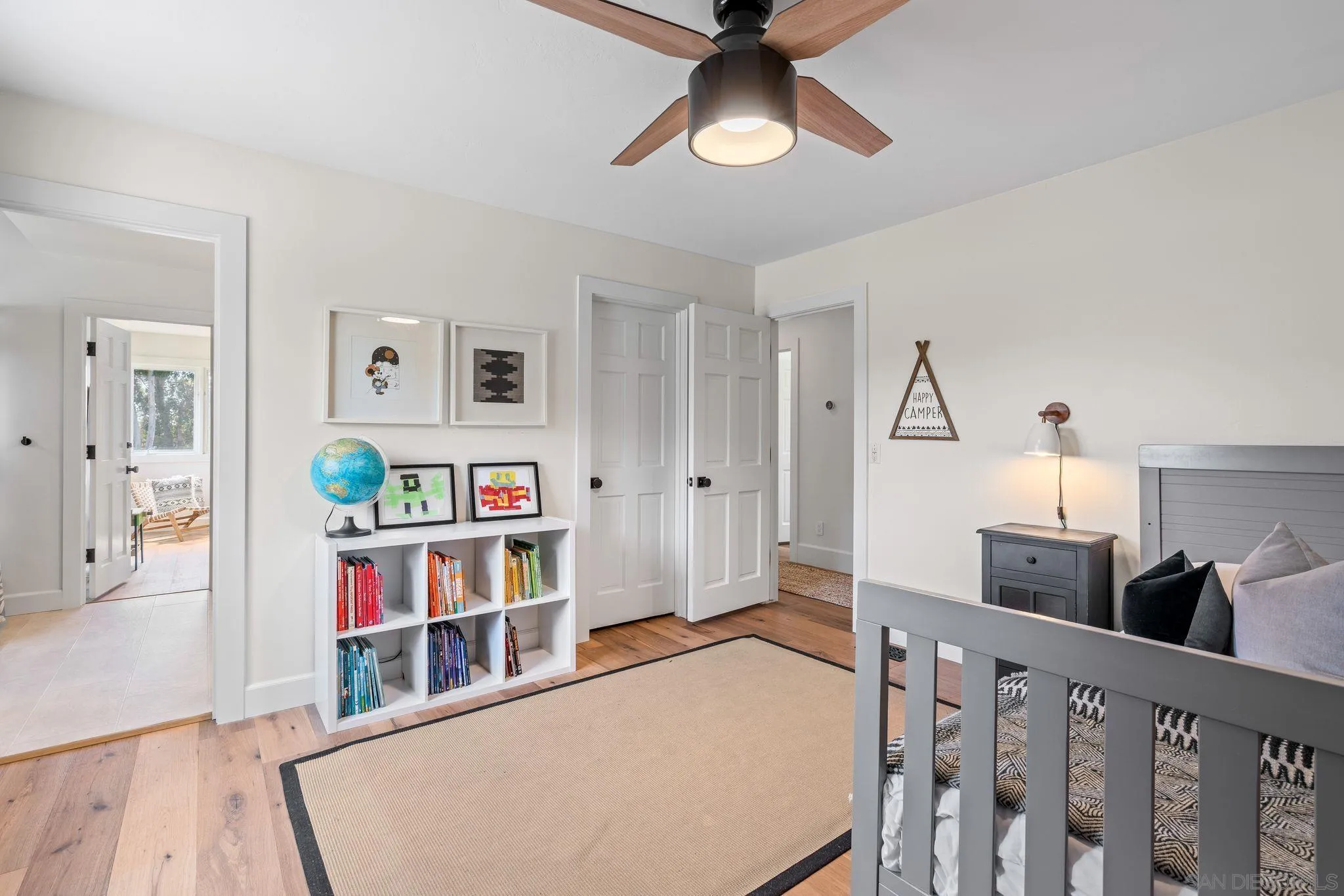 3355 Dove Hollow Road Encinitas, CA 92024 - Photo 22 of 37 a living room with lots of furniture and a book shelf