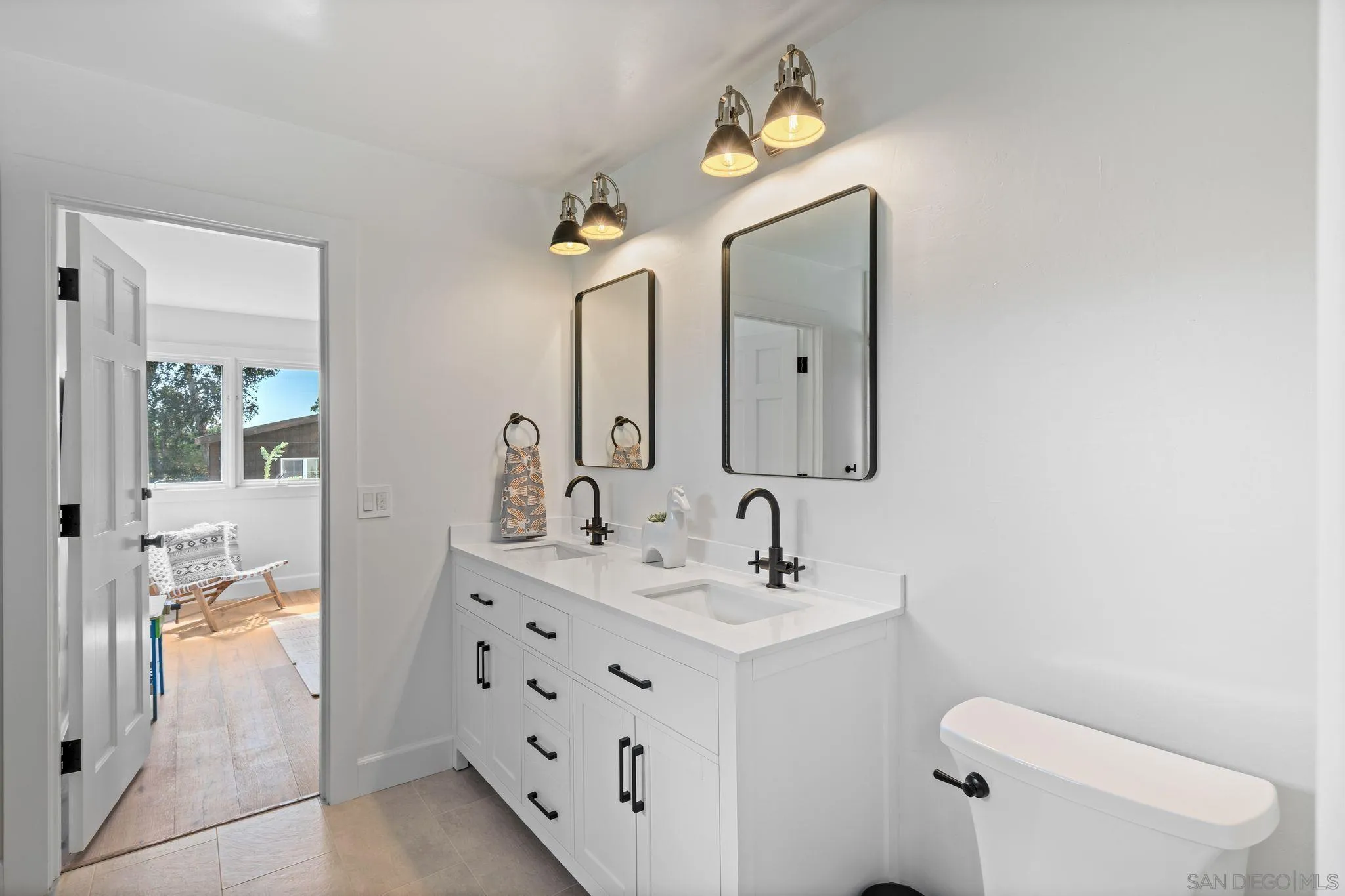 3355 Dove Hollow Road Encinitas, CA 92024 - Photo 23 of 37 a bathroom with a double vanity sink and mirror