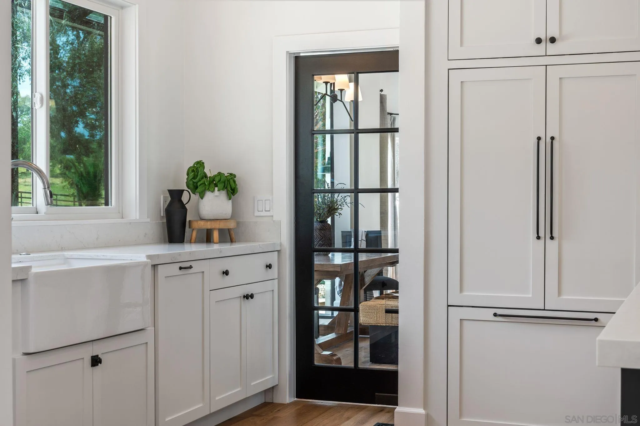 3355 Dove Hollow Road Encinitas, CA 92024 - Photo 10 of 37 a white painted room with window and wooden door