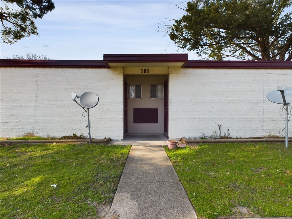 308 Ehlinger Drive, Unit C Bryan, TX 77801 - Photo 1 of 15 a front view of a house with a yard