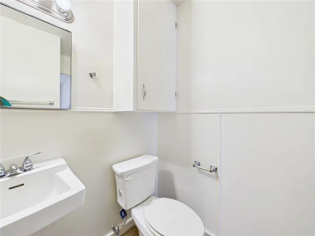 a white toilet sitting next to a bathroom sink