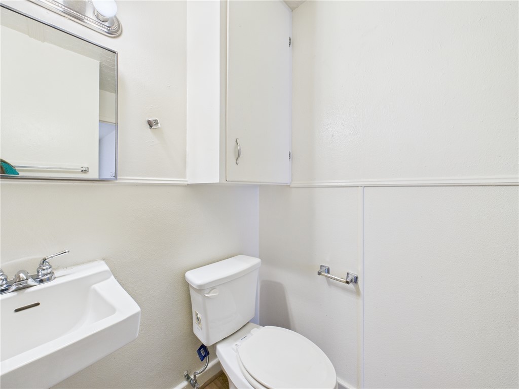 308 Ehlinger Drive, Unit C Bryan, TX 77801 - Photo 12 of 15 a white toilet sitting next to a bathroom sink