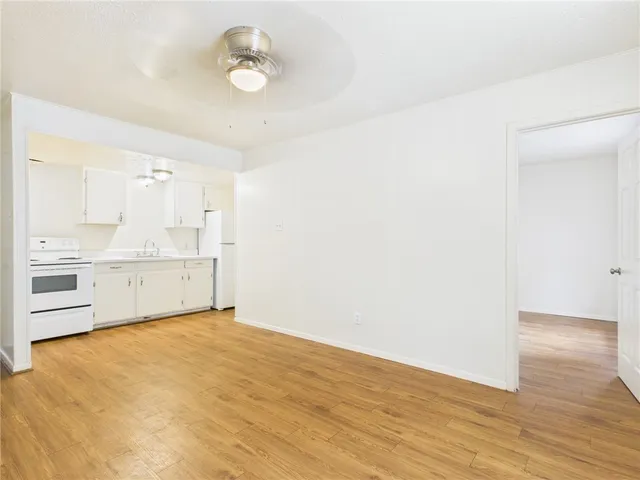a view of a kitchen with wooden floor and a sink