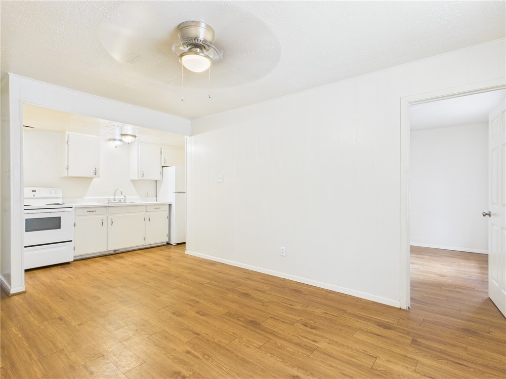 308 Ehlinger Drive, Unit C Bryan, TX 77801 - Photo 3 of 15 a view of a kitchen with wooden floor and a sink
