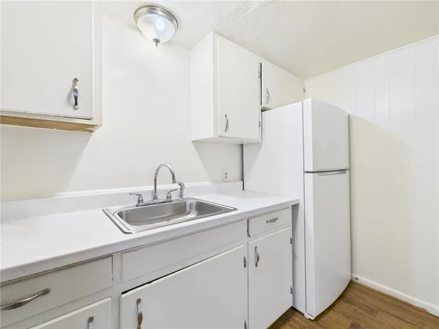 a kitchen with a sink and a refrigerator
