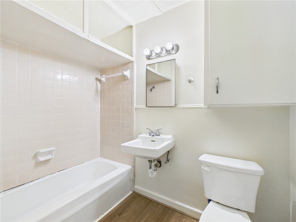 308 Ehlinger Drive, Unit C Bryan, TX 77801 - Photo 10 of 15 a bathroom with a sink a toilet and a mirror