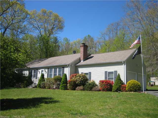 a front view of a house with a garden and yard