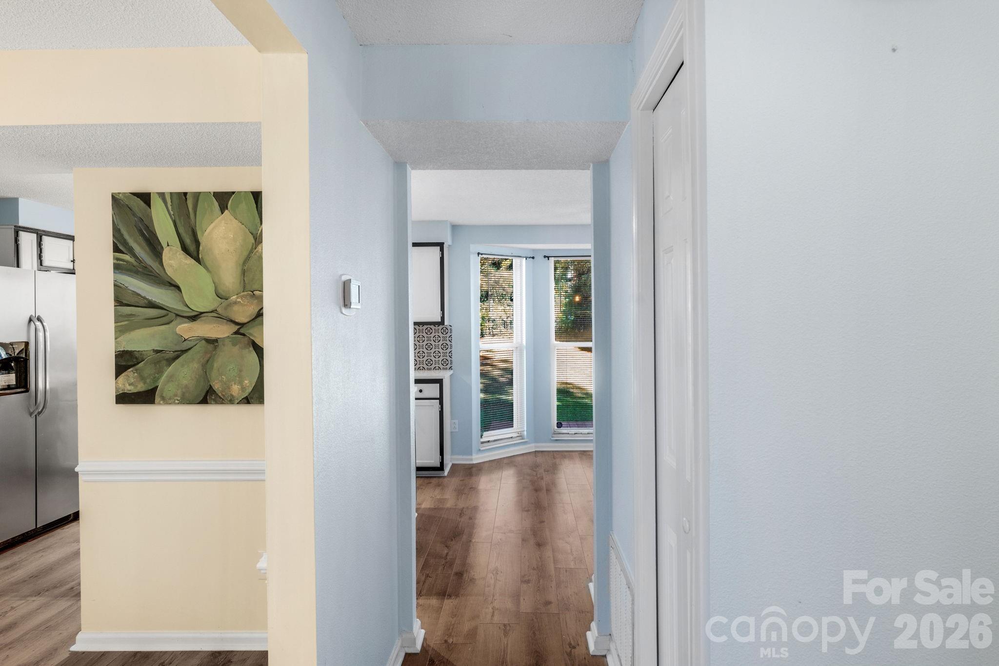 12006 Woodside Falls Road Pineville, NC 28134 - Photo 11 of 48 a view of a hallway with wooden floor and a living room