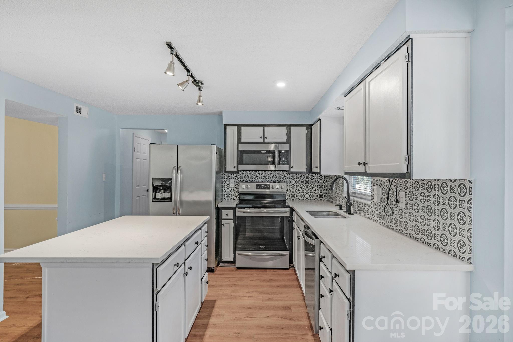 12006 Woodside Falls Road Pineville, NC 28134 - Photo 13 of 48 a kitchen with stainless steel appliances granite countertop a sink stove and refrigerator