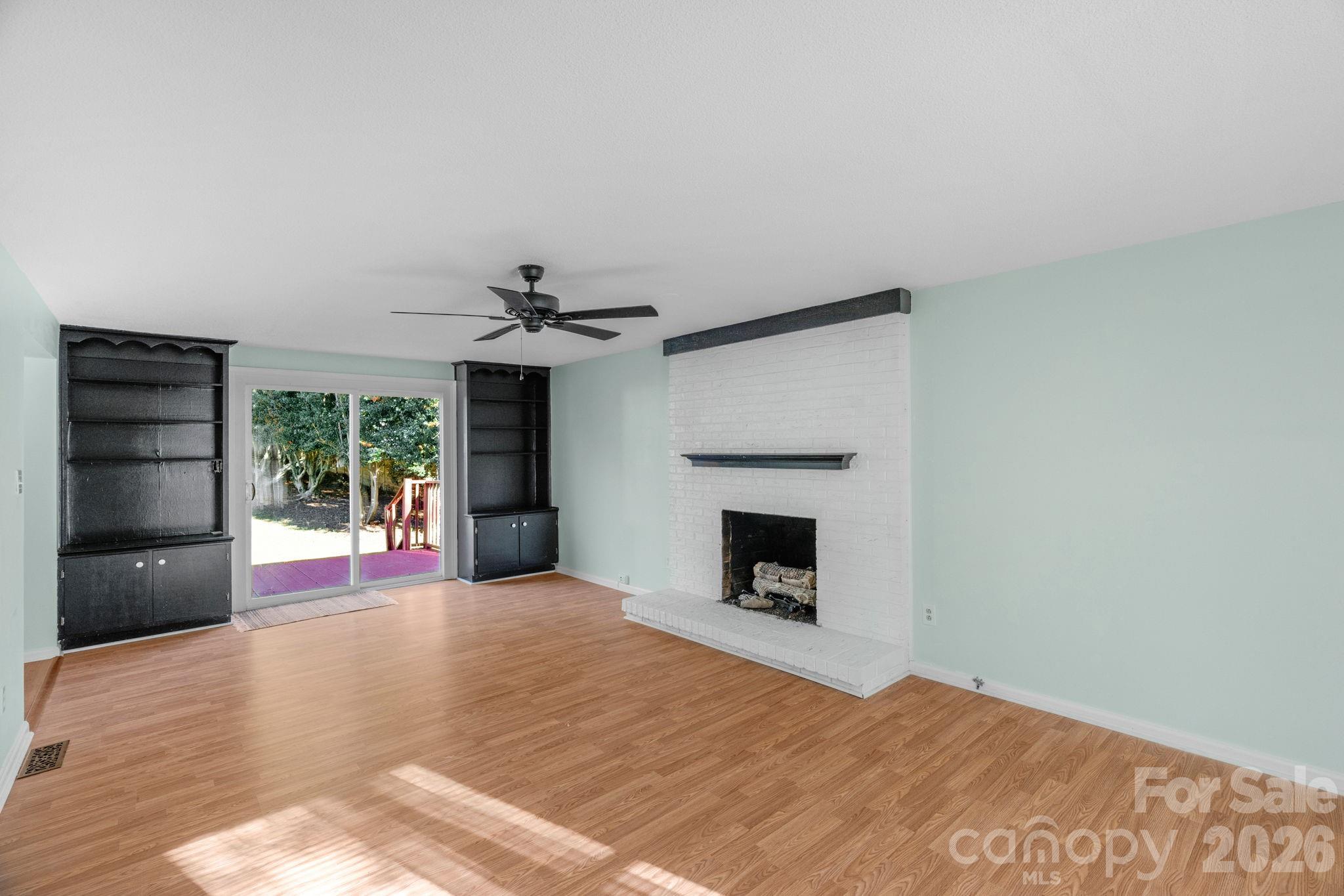 12006 Woodside Falls Road Pineville, NC 28134 - Photo 19 of 48 a view of an empty room with a fireplace and a window