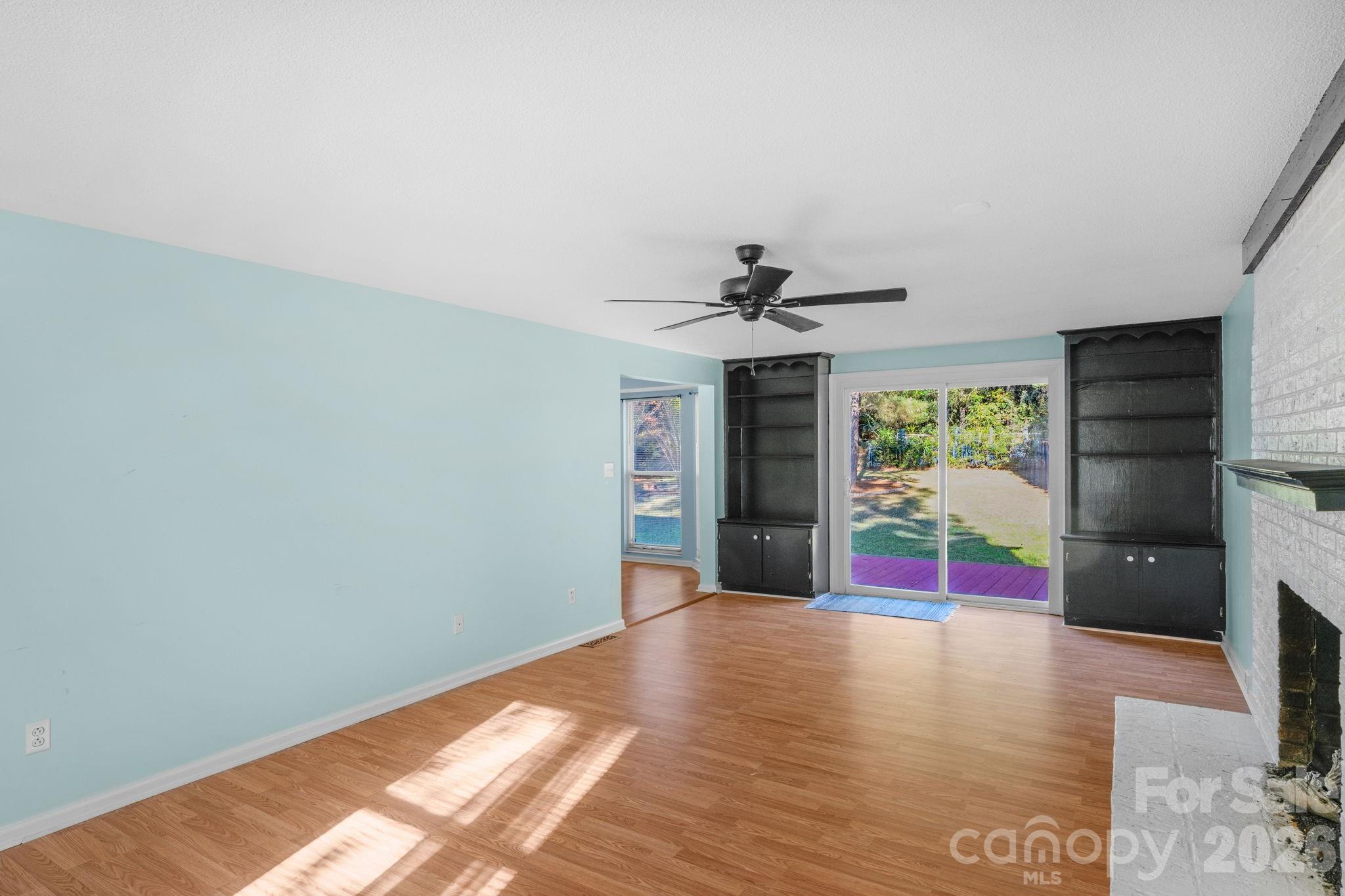 12006 Woodside Falls Road Pineville, NC 28134 - Photo 20 of 48 a view of empty room with wooden floor and fan