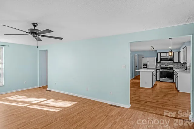 a view of a kitchen with wooden floor and a sink