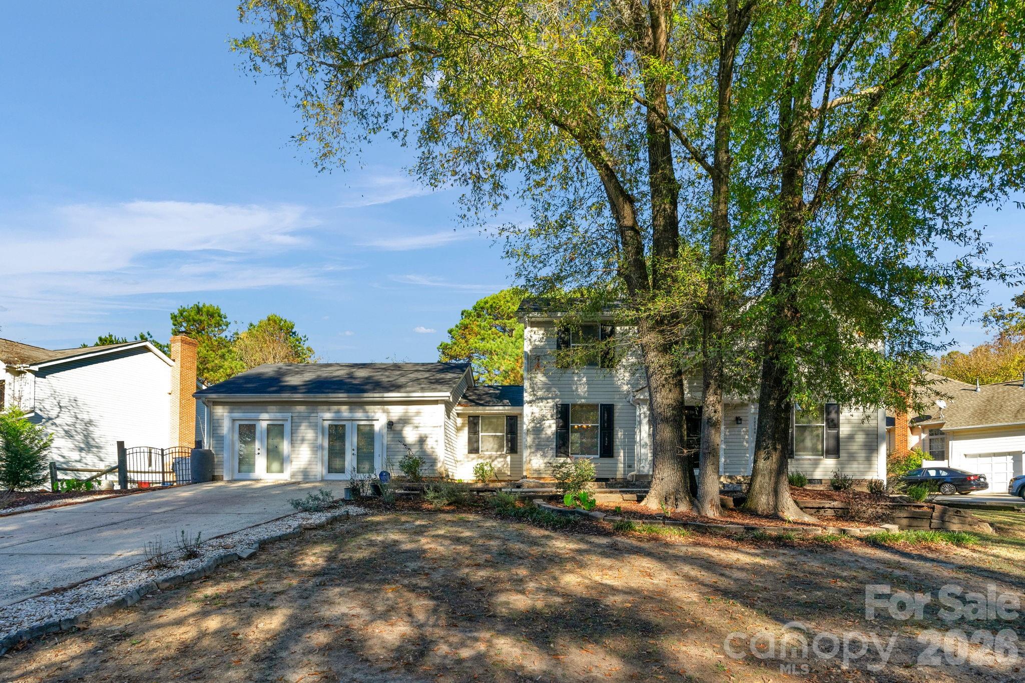 12006 Woodside Falls Road Pineville, NC 28134 - Photo 3 of 48 a front view of a house with garden