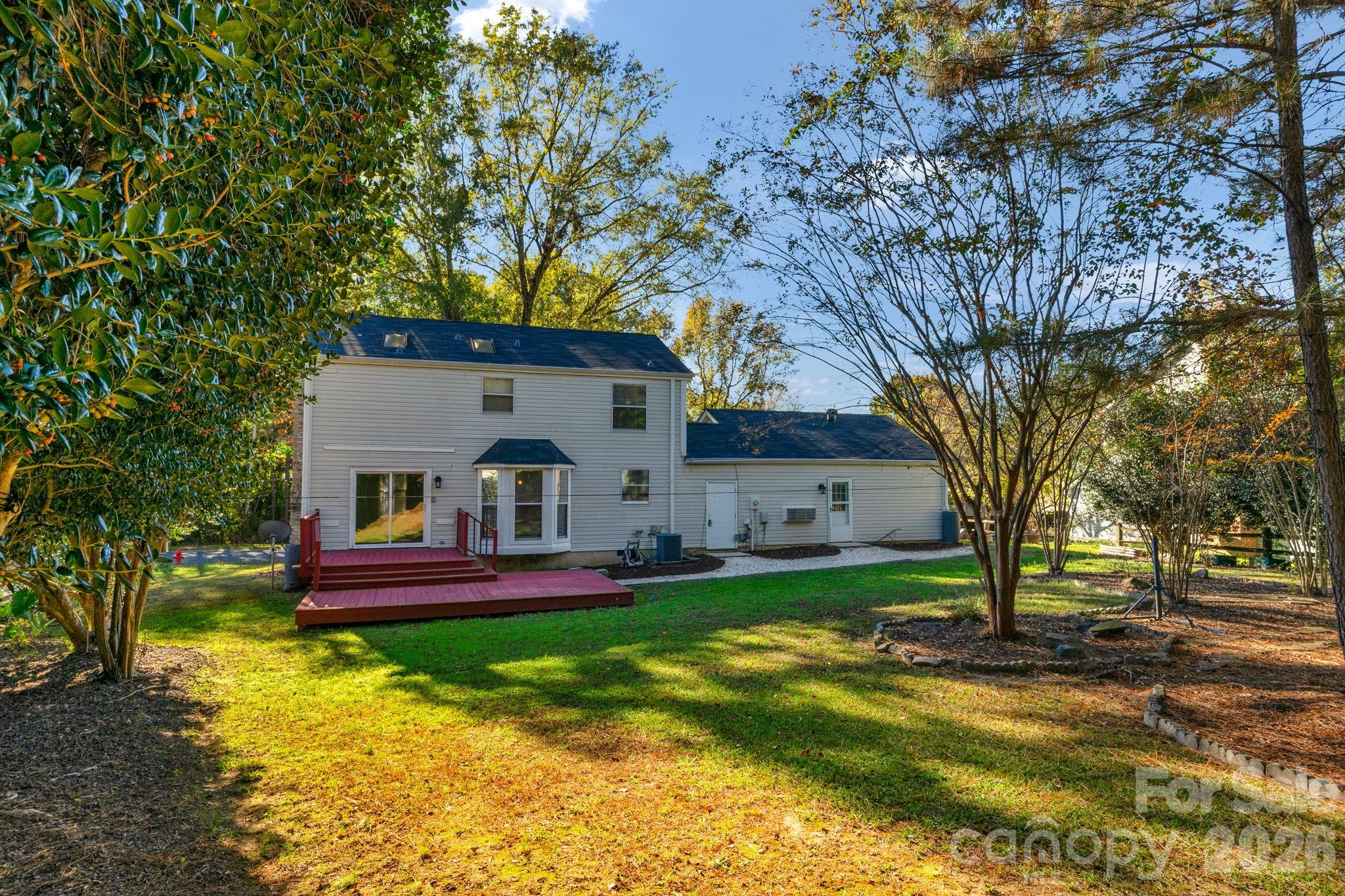 12006 Woodside Falls Road Pineville, NC 28134 - Photo 34 of 48 a front view of a house with a yard table and chairs