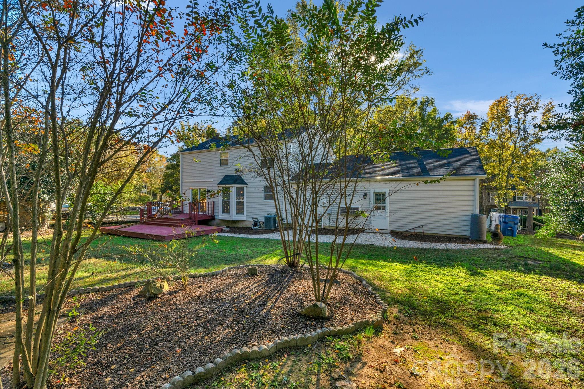 12006 Woodside Falls Road Pineville, NC 28134 - Photo 37 of 48 a view of a house with backyard and tree