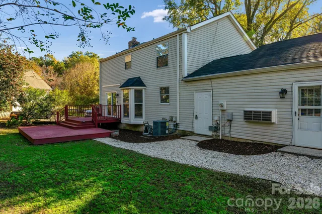 a view of a house with a yard and sitting area