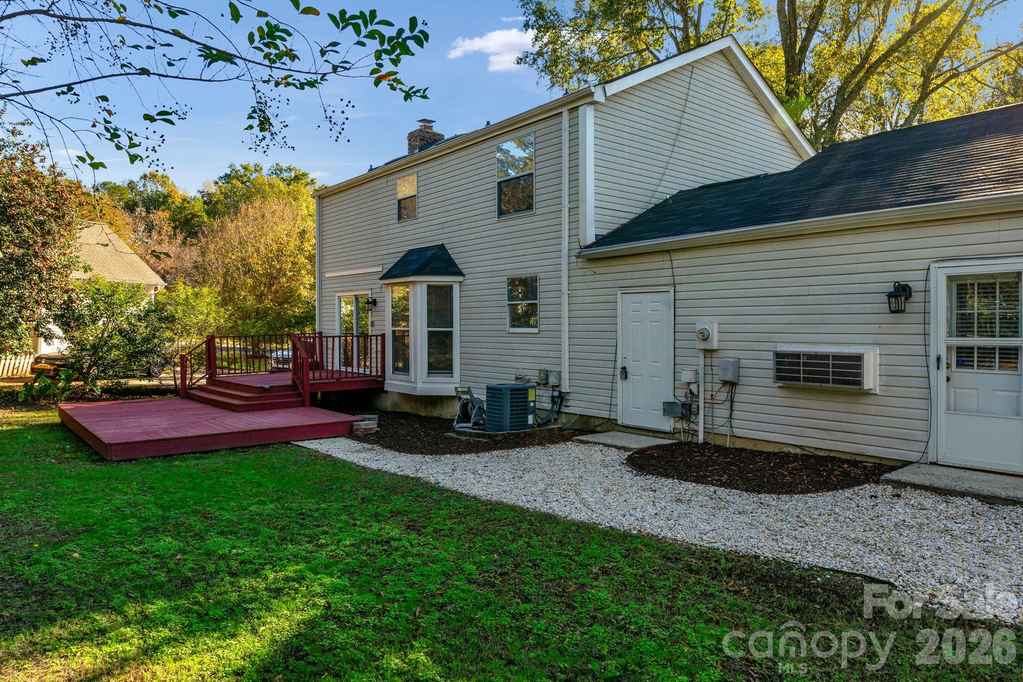 12006 Woodside Falls Road Pineville, NC 28134 - Photo 38 of 48 a view of a house with a yard and sitting area