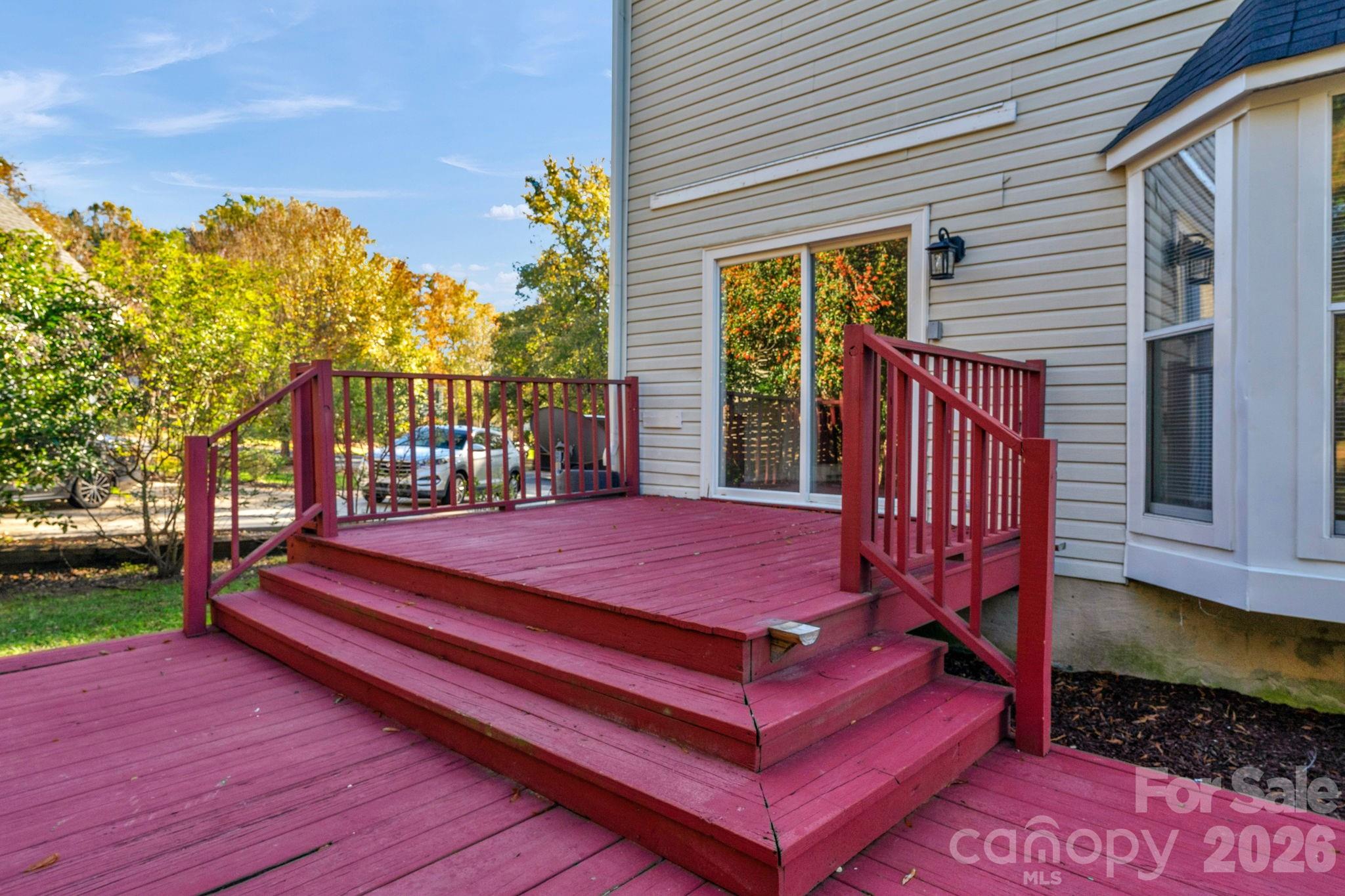 12006 Woodside Falls Road Pineville, NC 28134 - Photo 40 of 48 a patio with table and chairs with wooden floor and fence