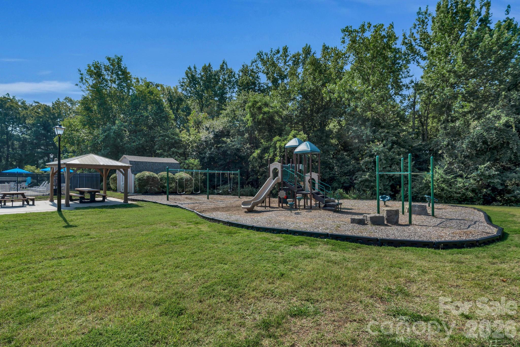 12006 Woodside Falls Road Pineville, NC 28134 - Photo 44 of 48 a view of a house with backyard and sitting area