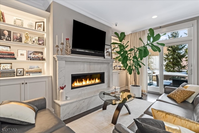 206 Echo Ridge Way, Unit 206 Mountainside, NJ 07092 - Photo 12 of 35 a living room with furniture a flat screen tv and a fireplace