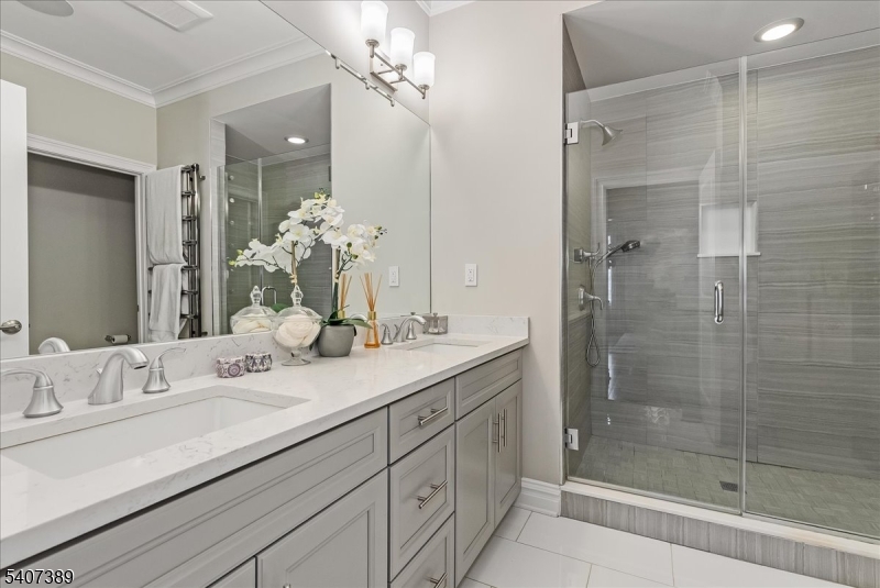 206 Echo Ridge Way, Unit 206 Mountainside, NJ 07092 - Photo 17 of 35 a bathroom with a shower sink double and mirror