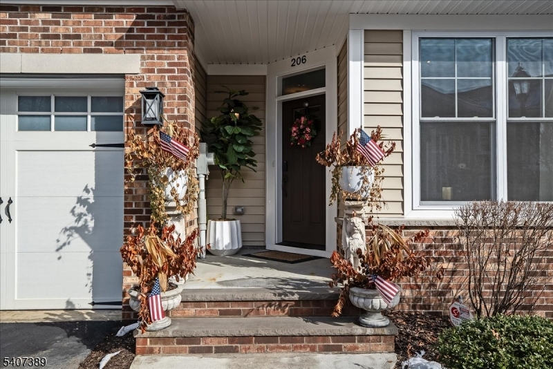 206 Echo Ridge Way, Unit 206 Mountainside, NJ 07092 - Photo 2 of 35 front view of a house with a window and potted plants