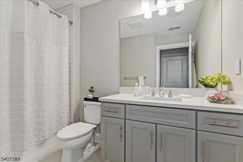 206 Echo Ridge Way, Unit 206 Mountainside, NJ 07092 - Photo 22 of 35 a bathroom with a granite countertop sink and a mirror