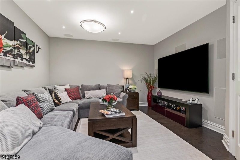 206 Echo Ridge Way, Unit 206 Mountainside, NJ 07092 - Photo 29 of 35 a living room with furniture and a flat screen tv