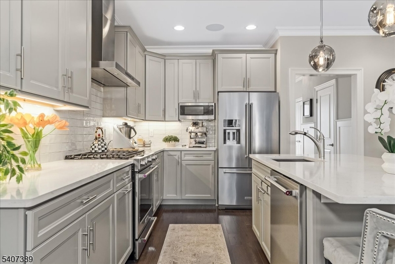 206 Echo Ridge Way, Unit 206 Mountainside, NJ 07092 - Photo 9 of 35 a kitchen with a sink stainless steel appliances a counter top space and cabinets