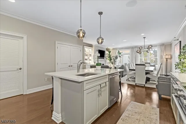 a kitchen with stainless steel appliances granite countertop a sink stove and wooden floor
