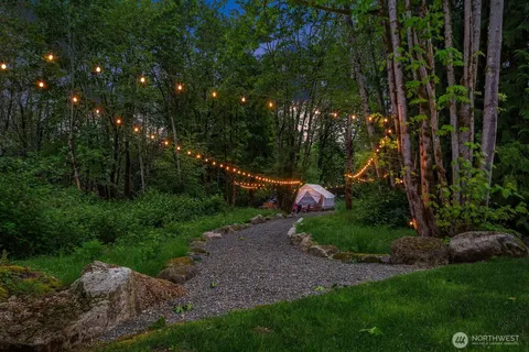 a backyard of a house with fire pit and outdoor seating