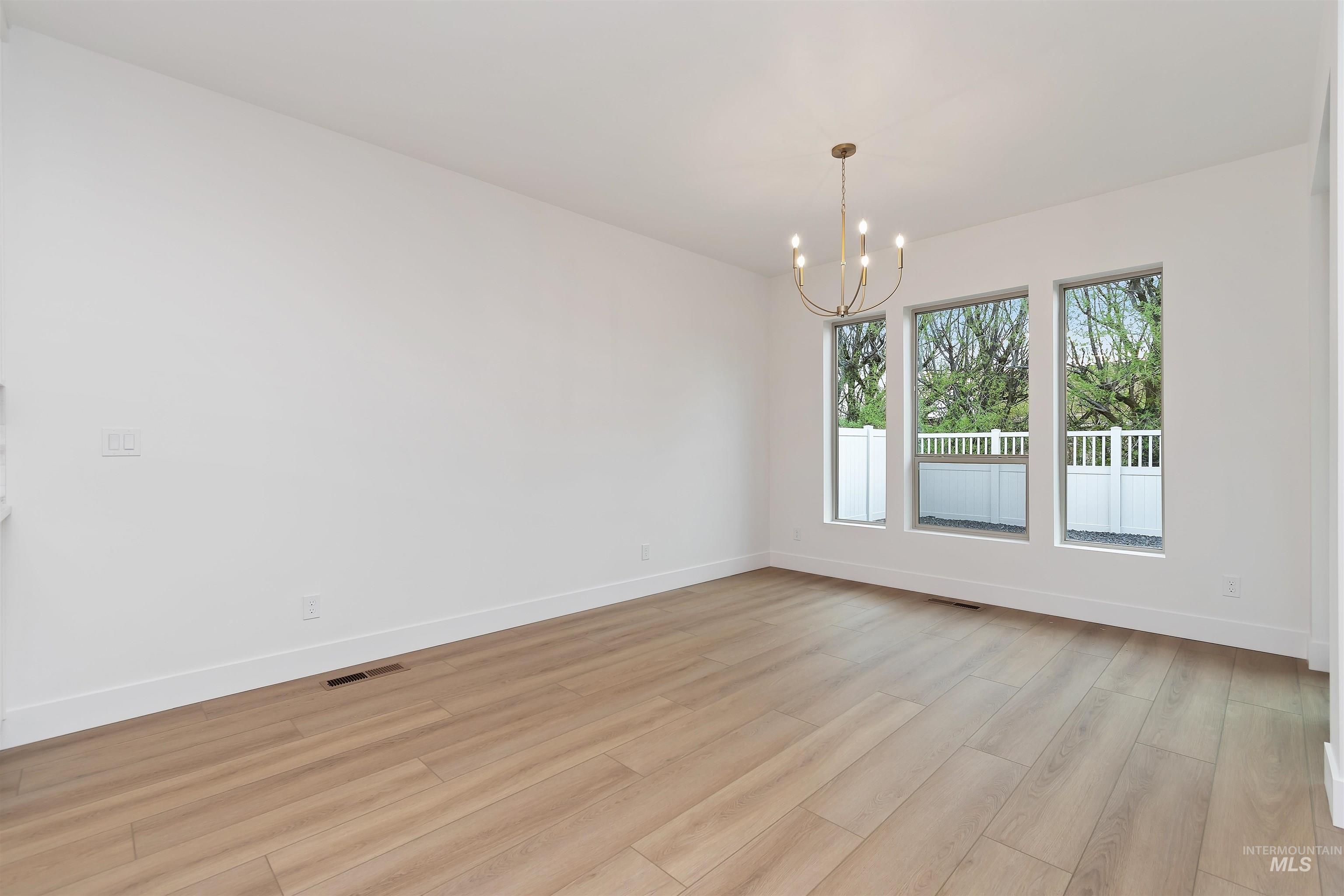 4302 Tropic Way Caldwell, ID 83607 - Photo 14 of 32 Spare room with hanging lights and light wood finished floors