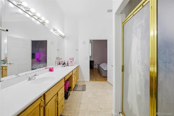 a bathroom with a tub sink and mirror