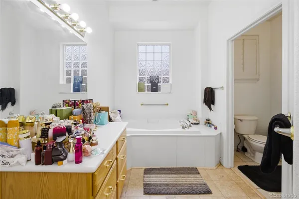 a bathroom with a tub sink and mirror