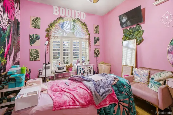 a bedroom with a bed mirror and a window