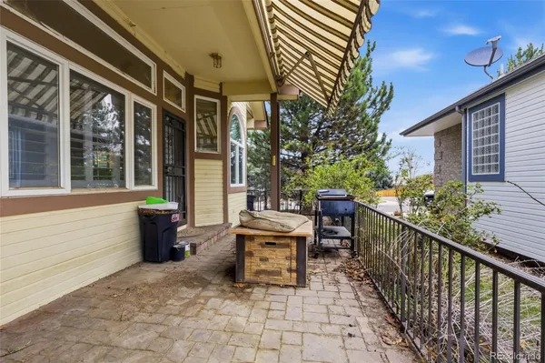 a view of a patio with table and chairs and potted plants