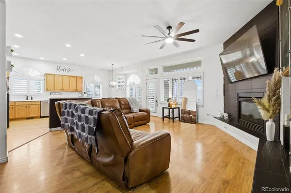 a living room with furniture a flat screen tv and a fireplace