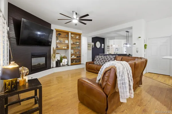 a living room with fireplace furniture and a flat screen tv