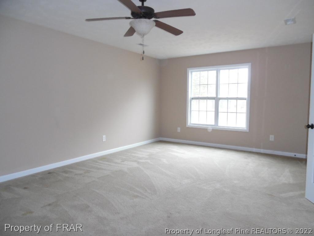 19 Swain Street Spring Lake, NC 28390 - Photo 23 of 30 an empty room with a window and a fan