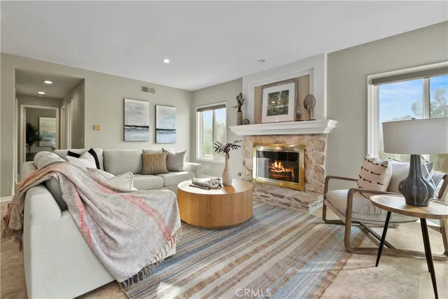 a dining room with furniture a chandelier and wooden floor