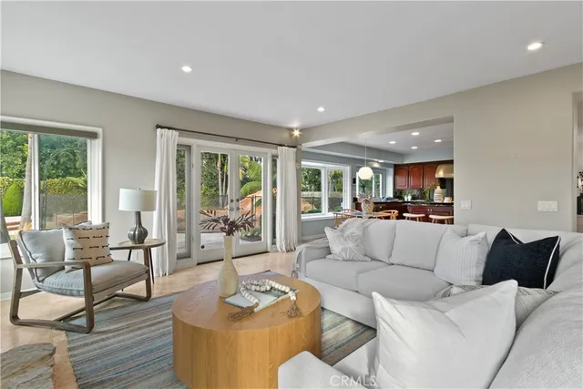 a kitchen with stainless steel appliances granite countertop a stove a refrigerator a kitchen island a table and chairs