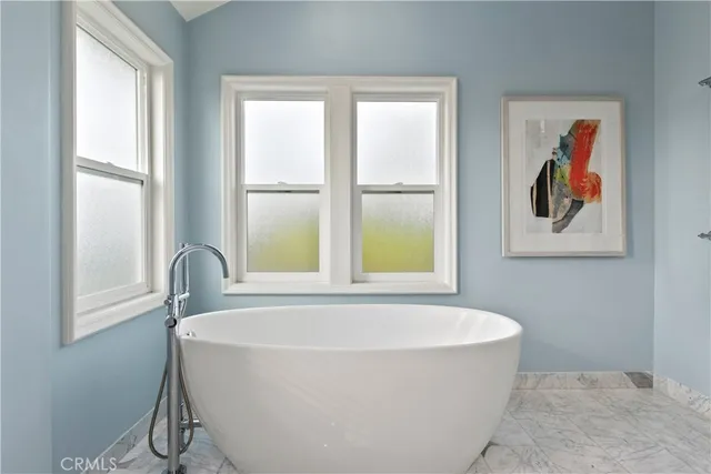 a bathroom with a granite countertop sink a toilet a mirror and shower