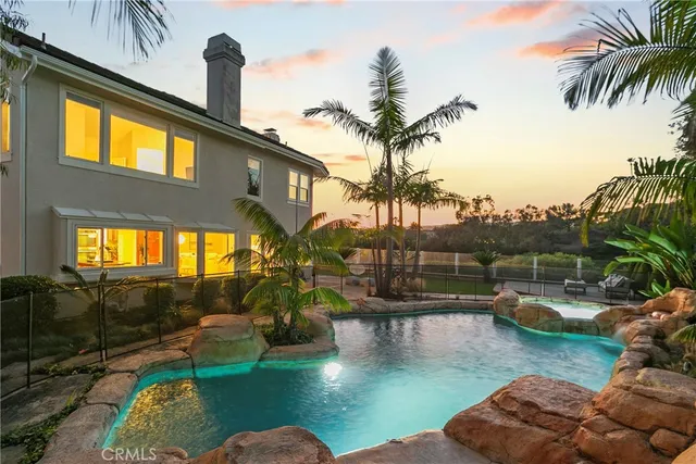 a view of a patio with couches table and chairs potted plants and palm trees