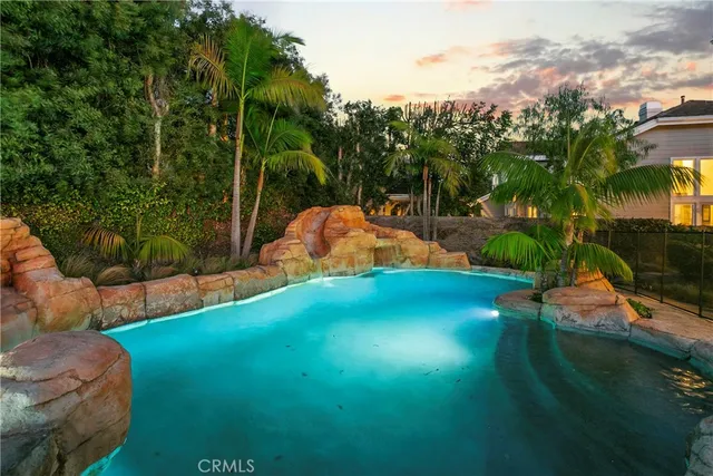 a view of backyard with swimming pool and outdoor seating