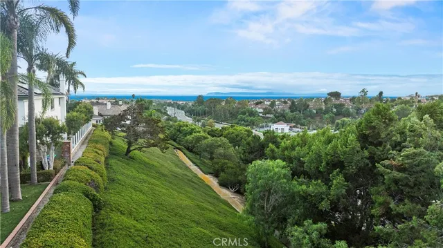 an aerial view of residential houses with outdoor space and swimming pool